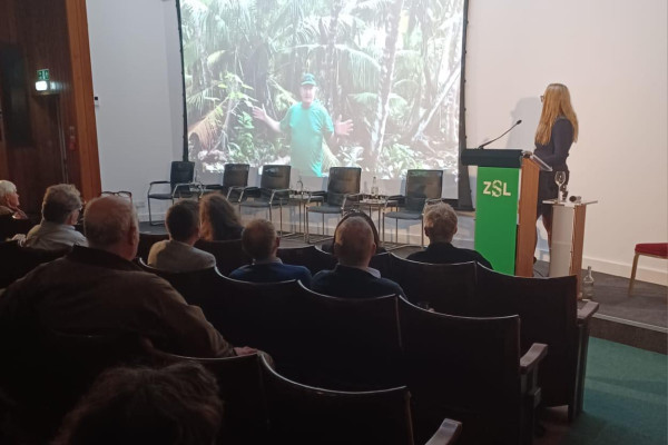 side view of an audience seated and focused on speaker event
