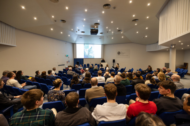 Back view of a large audience seated and focused on speaker at the CCT annual event